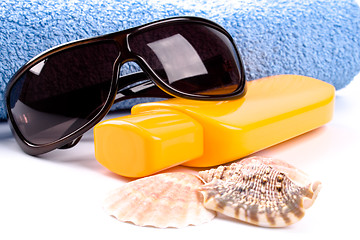 Image showing towel, shells, sunglasses and lotion