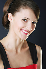 Image showing Toothy smiling brunette in red