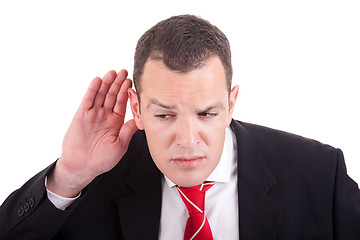 Image showing businessman, listening, viewing the  gesture of hand behind the ear, isolated on white background