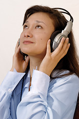 Image showing Girl in a blue shirt with headphones