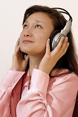 Image showing Girl in a red shirt with headphones