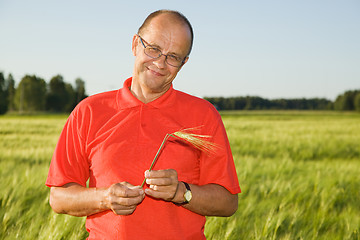 Image showing Middle-aged man smiling on a field