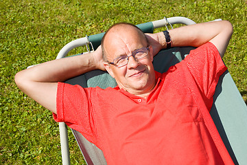 Image showing Happy man lying on hammock