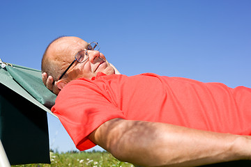 Image showing Happy man lying on hammock