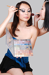 Image showing Two Chinese girls doing makeup.