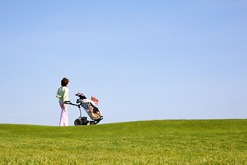 Image showing Golfer and caddy