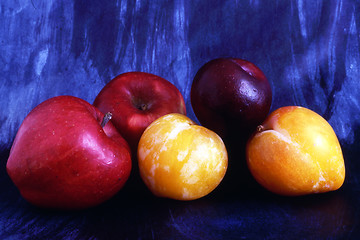 Image showing Apples and plums isolated on painted background