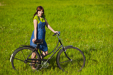 Image showing Girl with a bicycle