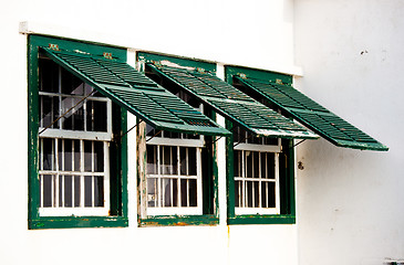 Image showing Three old green windows from a typical beach house.
