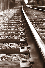 Image showing Rail road tracks. Black and white sepia. Close-up