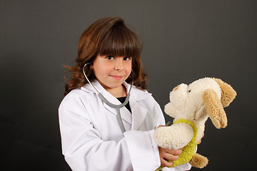 Image showing Little girl with stuffed dog
