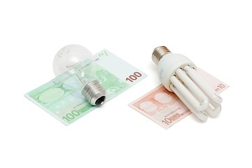 Image showing Energy save lamp versus bulb on euro bills isolated