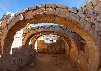 Image showing Converging ancient stone arches 