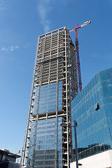 Image showing Lifting crane at skyscraper construction site