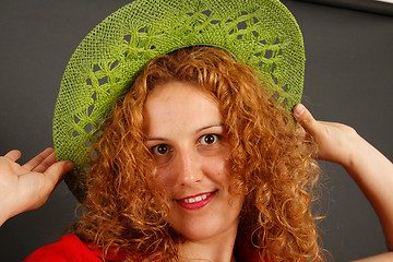 Image showing Girl trying on a green hat