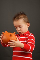 Image showing Child and is piggy bank