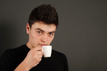 Image showing Young guy drinking coffee