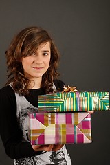 Image showing Girl holding some gifts and smiling