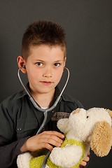 Image showing Little boy with stuffed dog
