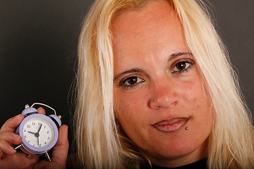 Image showing Blo-hair woman holding a clock