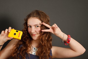 Image showing A young girl with a disposable camera