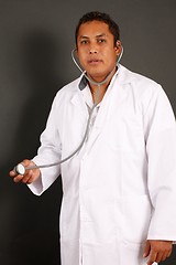Image showing Doctor with percing standing isolated over a black background
