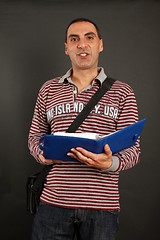 Image showing Man reading a day times book 