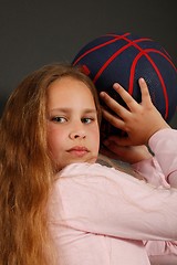 Image showing Young girl play with a basketball ball