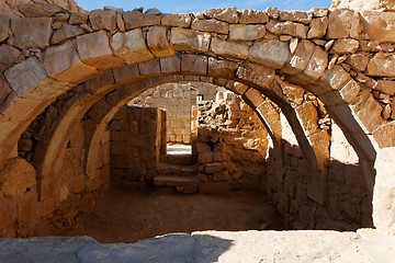 Image showing Converging ancient stone arches 