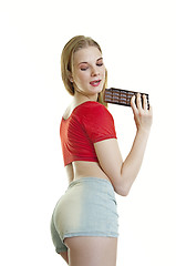 Image showing young woman eating chocolate 