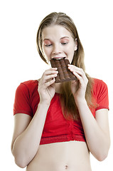 Image showing young woman enjoying chocolate bar 