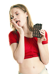 Image showing young woman enjoying large  chocolate  bar