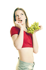 Image showing young woman eating grapes