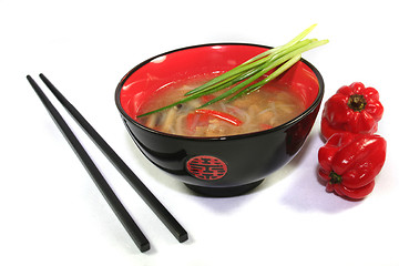 Image showing Thai soup with chopsticks and red pepper