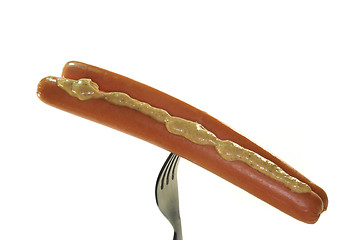 Image showing Wiener Wüstchen with mustard on a fork