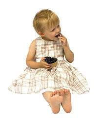 Image showing Child eating blueberries