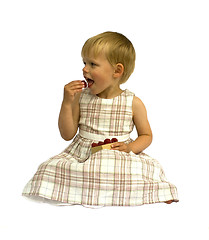 Image showing Child eating raspberries