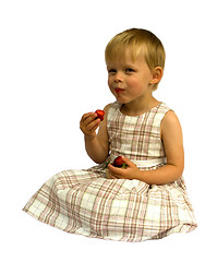Image showing Child eating strawberries