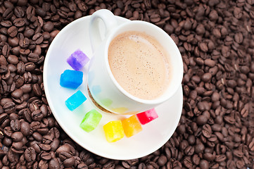 Image showing Multicolored slabs of shugar and cup of coffee 