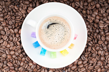 Image showing Multicolored slabs of shugar and cup of coffee 