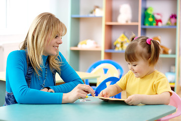 Image showing Teacher with child in preschool