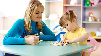 Image showing Teacher with child in preschool