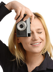 Image showing young woman taking a shot with photo camera