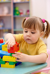 Image showing Little girl play with building bricks in preschool