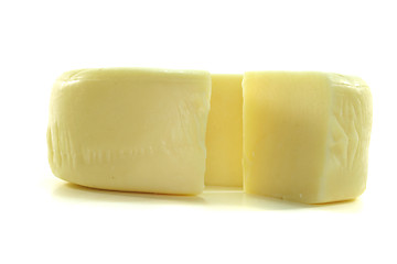 Image showing Cheese wheel with a piece of cheese