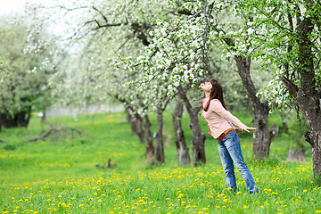 Image showing Woman smelling flowers