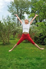 Image showing Young woman practising - jump