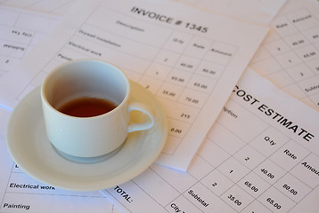 Image showing Half Empty Cup of Tea on Financial Documents