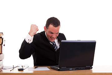Image showing businessman in front of the computer, arm raised and happy