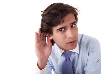 Image showing Young businessman, listening, viewing the  gesture of hand behind the ear